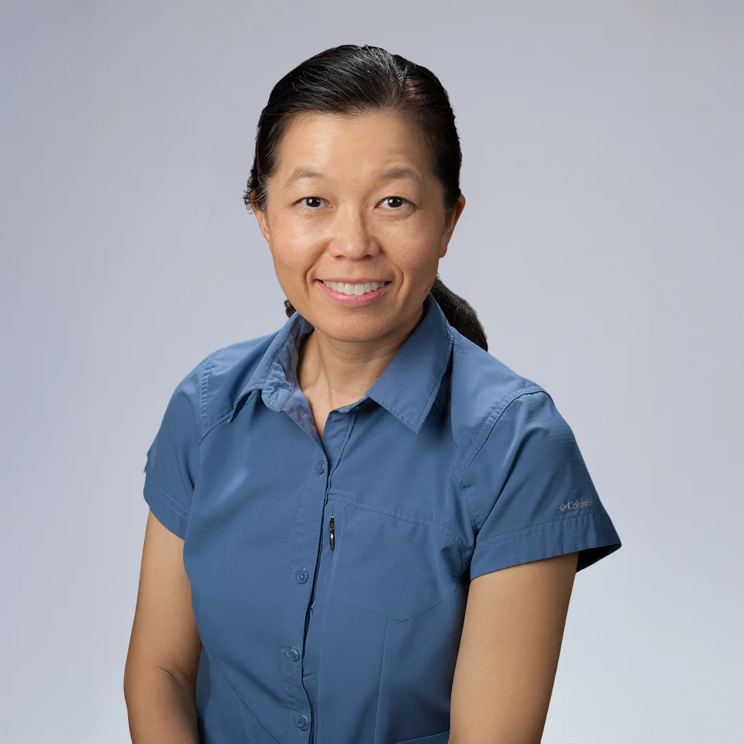 Person in blue shirt, neutral background.