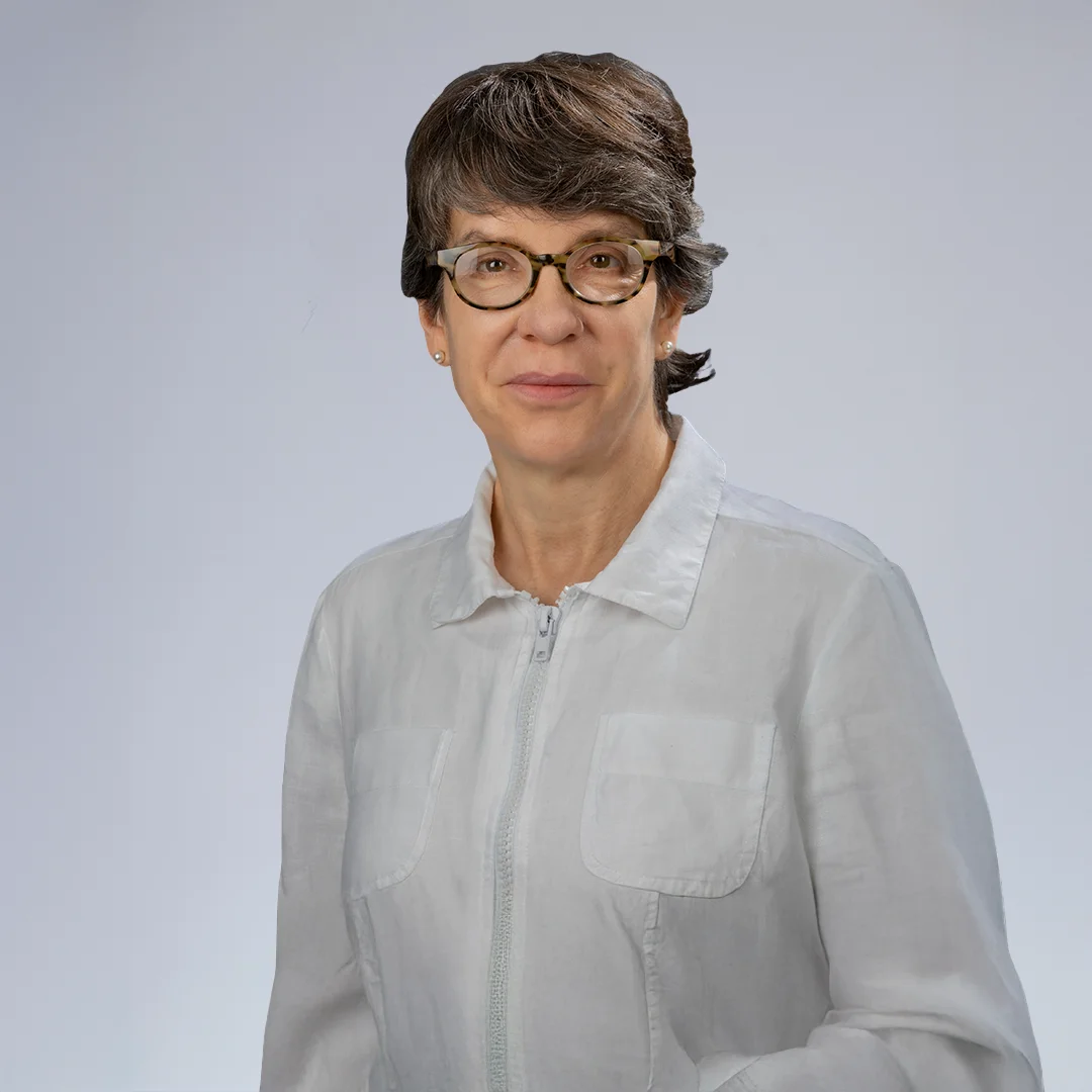 Person in white jacket, neutral background.