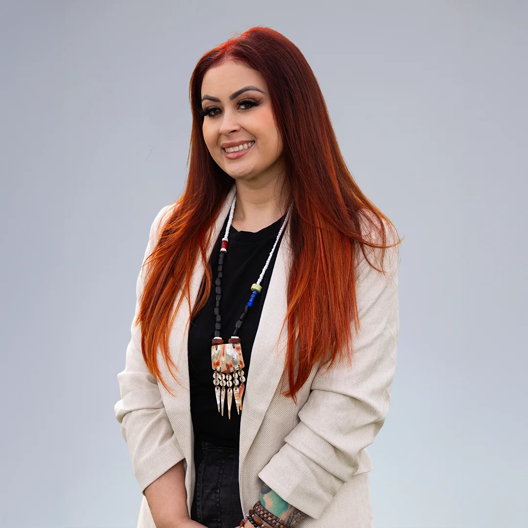 Woman with long red hair, jewelry.