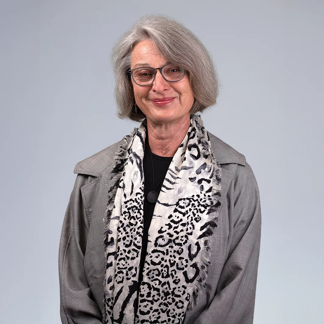 Woman wearing a patterned scarf.