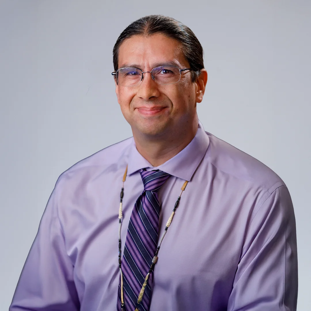 Man in purple shirt and tie