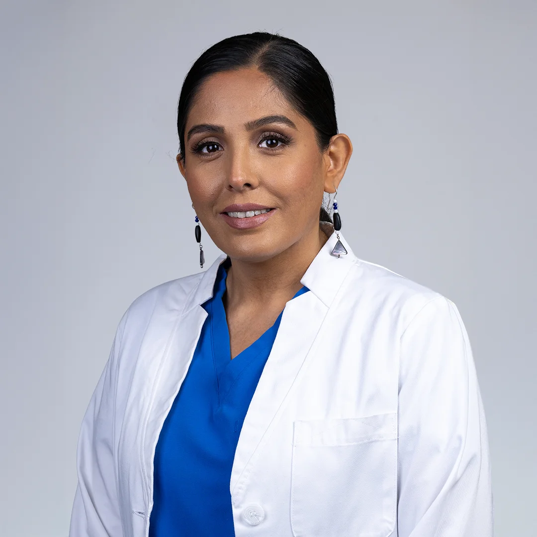 Person in medical attire, professional setting.