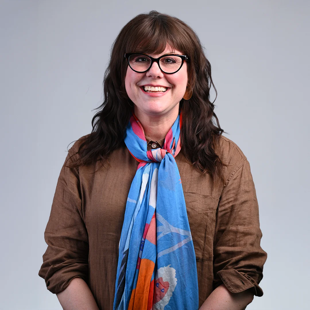 Smiling woman with glasses and scarf