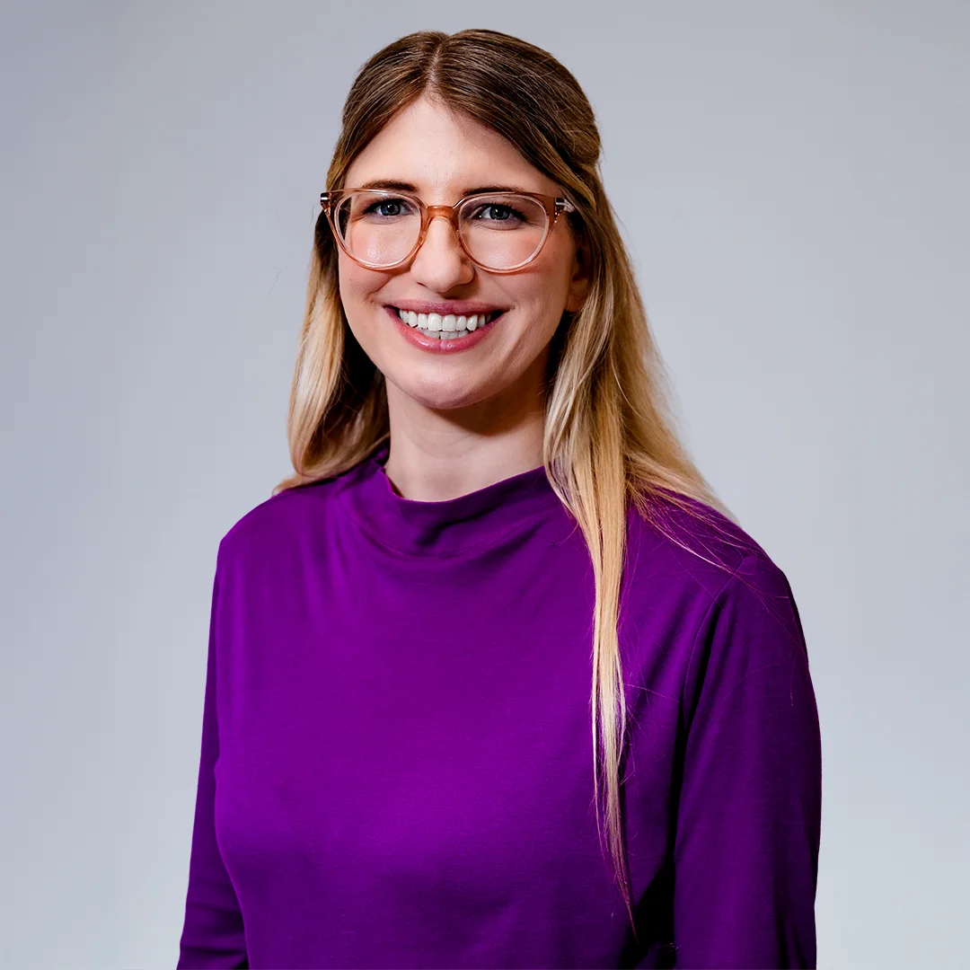 Smiling woman in purple top